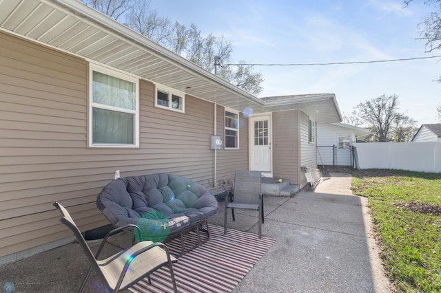 view of patio featuring fence and driveway
