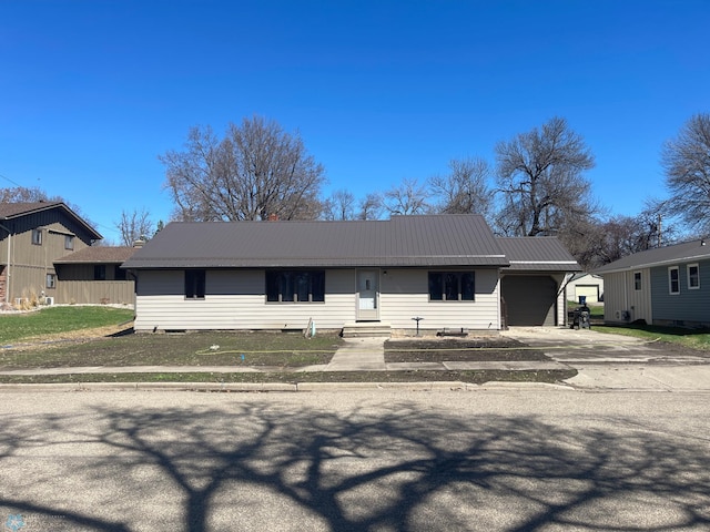101 Oak St, Lisbon, ND 58054 - ranch-style home featuring a garage, concrete driveway, metal roof, and entry steps