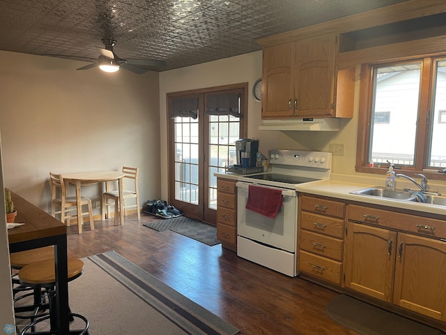 101 Oak St, Lisbon, ND 58054 - kitchen featuring white range with electric cooktop, a sink, dark wood-type flooring, under cabinet range hood, and ceiling fan