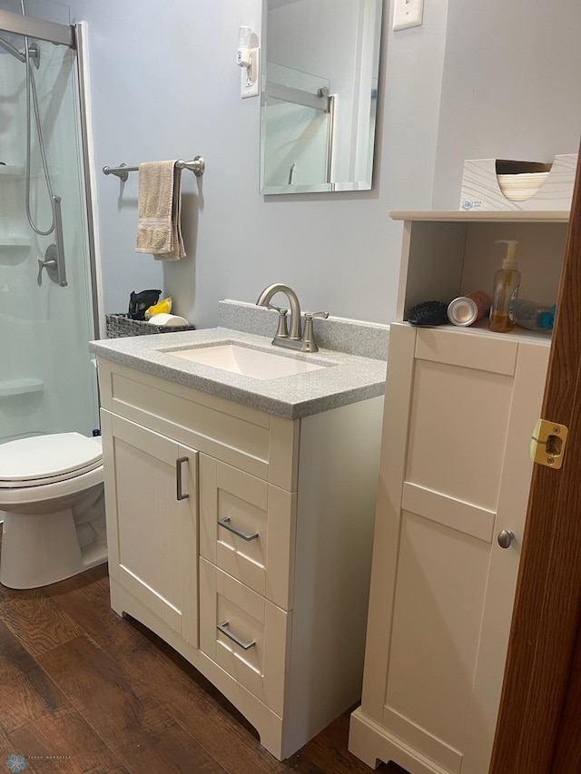 101 Oak St, Lisbon, ND 58054 - full bathroom featuring wood finished floors, a stall shower, vanity, and toilet