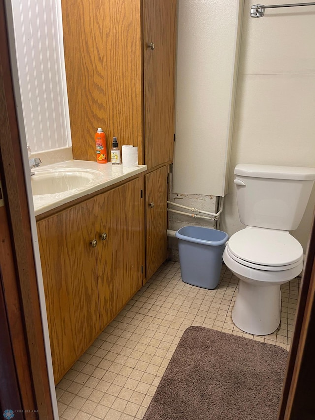 101 Oak St, Lisbon, ND 58054 - bathroom featuring toilet, vanity, and tile patterned flooring