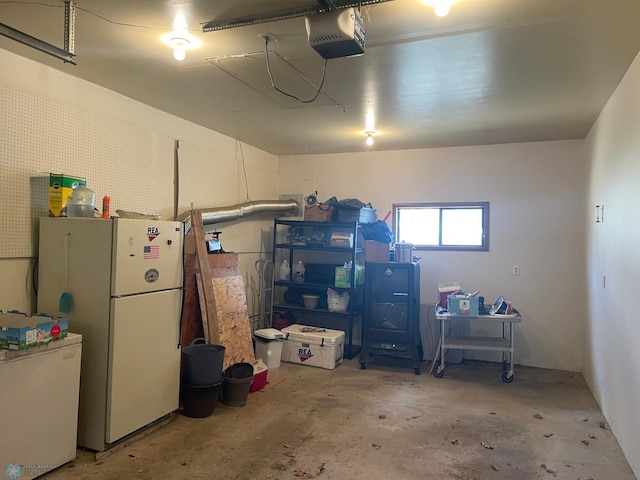 101 Oak St, Lisbon, ND 58054 - garage with freestanding refrigerator, refrigerator, and a garage door opener