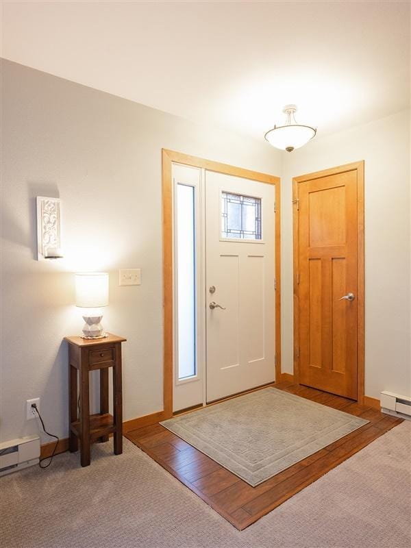 foyer entrance featuring baseboards and baseboard heating