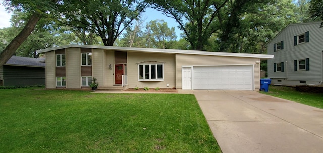 split level home with a garage, driveway, and a front yard