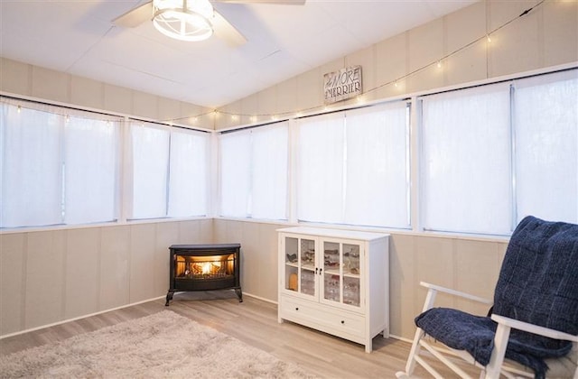 sunroom featuring a wood stove