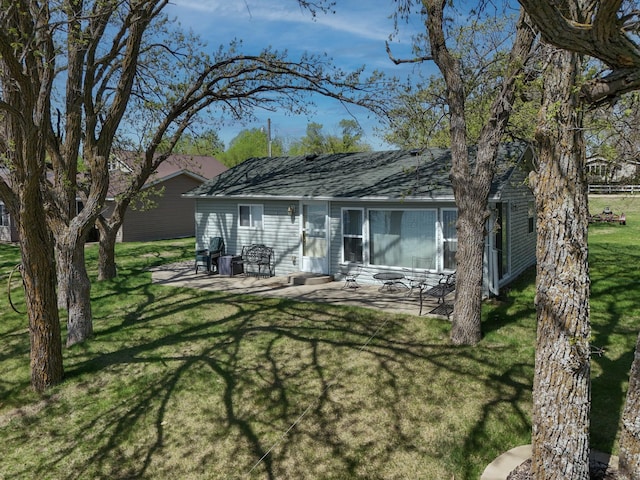 44948 Plentywood Rd, Perham, MN 56573 - back of property with a yard, a patio, and roof with shingles