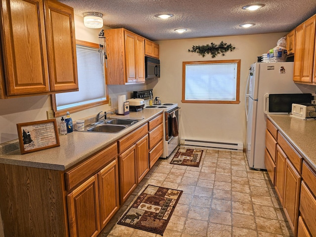 44948 Plentywood Rd, Perham, MN 56573 - kitchen featuring white appliances, baseboard heating, a sink, stone tile floors, and a textured ceiling