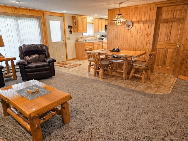 44948 Plentywood Rd, Perham, MN 56573 - dining space with wooden walls, a textured ceiling, and light carpet