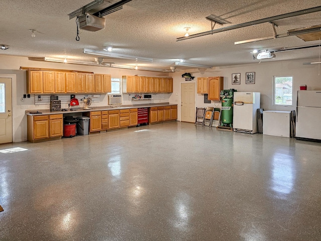 44948 Plentywood Rd, Perham, MN 56573 - garage with freestanding refrigerator and a garage door opener
