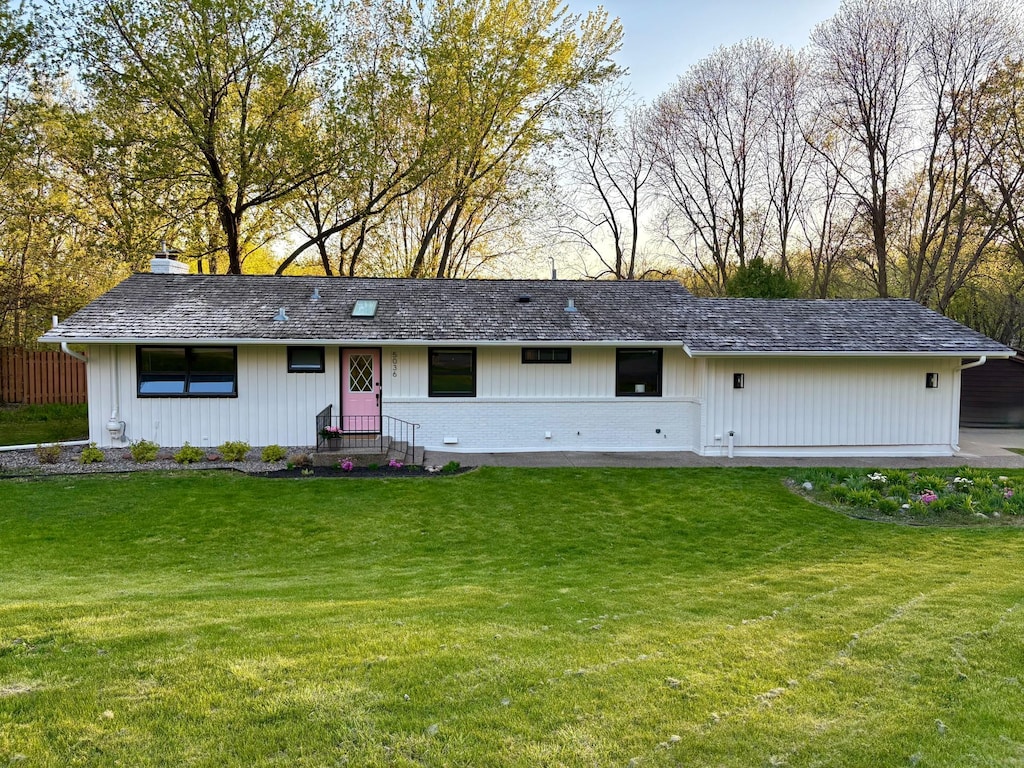 view of front of property featuring a front lawn and a chimney