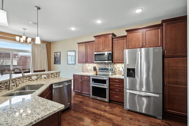 kitchen featuring stainless steel appliances, a sink, decorative backsplash, healthy amount of natural light, and recessed lighting