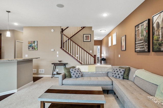 living area with stairs, light carpet, baseboards, and recessed lighting