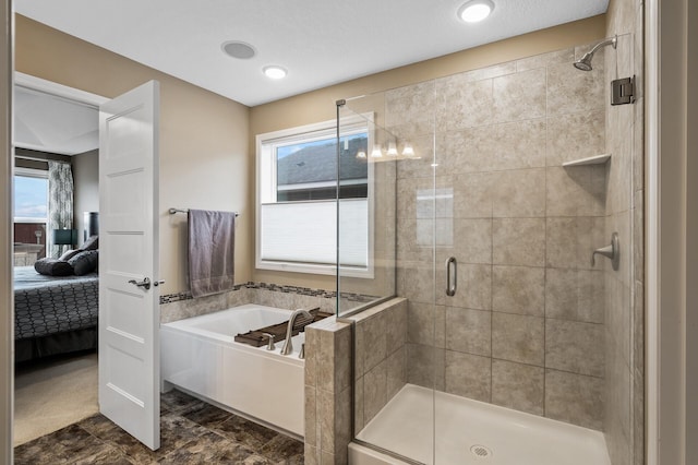 ensuite bathroom featuring a shower stall and a bath