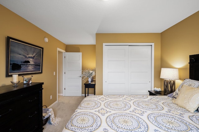 bedroom with a closet, baseboards, and carpet
