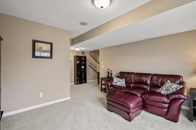 living area with light carpet, stairs, and baseboards
