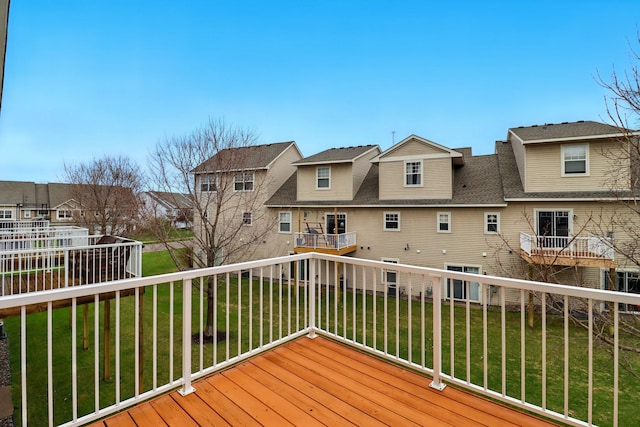 deck with a lawn and a residential view