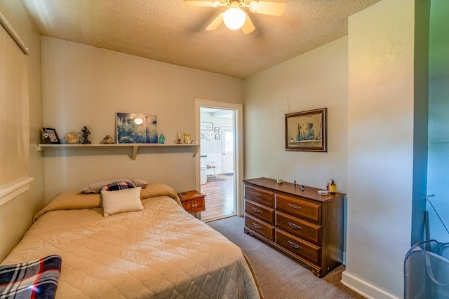 bedroom with dark carpet, a textured ceiling, and ceiling fan