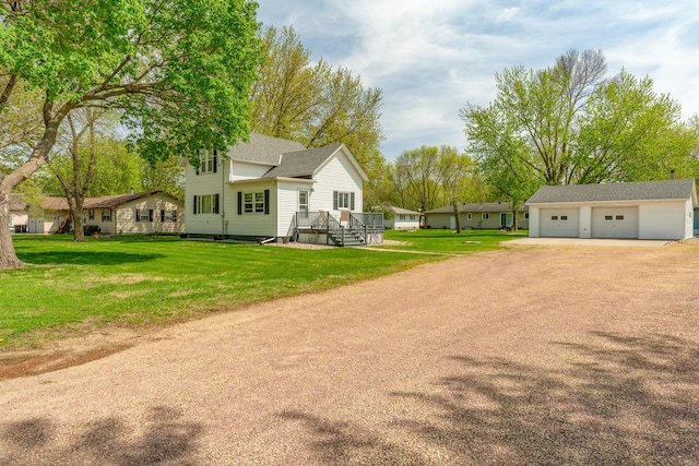 view of home's exterior featuring a garage, an outbuilding, a yard, and roof with shingles