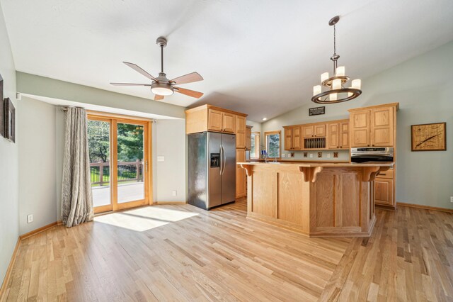 1036 Creekview Ln, Belle Plaine, MN 56011 - kitchen featuring stainless steel appliances, light wood finished floors, a breakfast bar, a ceiling fan, and lofted ceiling