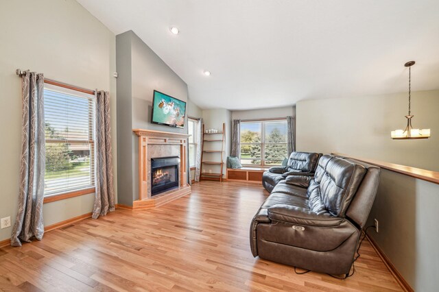 1036 Creekview Ln, Belle Plaine, MN 56011 - living room featuring lofted ceiling, a tiled fireplace, light wood-style flooring, baseboards, and recessed lighting