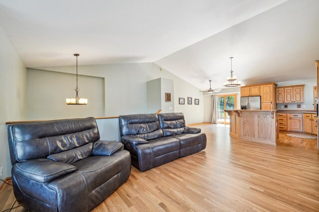 1036 Creekview Ln, Belle Plaine, MN 56011 - living area featuring light wood-style flooring, lofted ceiling, a ceiling fan, and a chandelier
