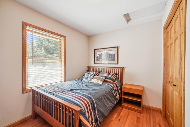 1036 Creekview Ln, Belle Plaine, MN 56011 - bedroom with attic access, light wood finished floors, baseboards, and a closet