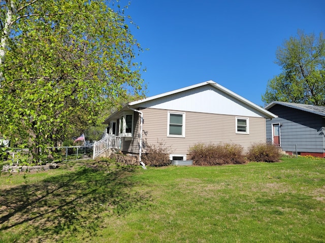 rear view of property with a yard
