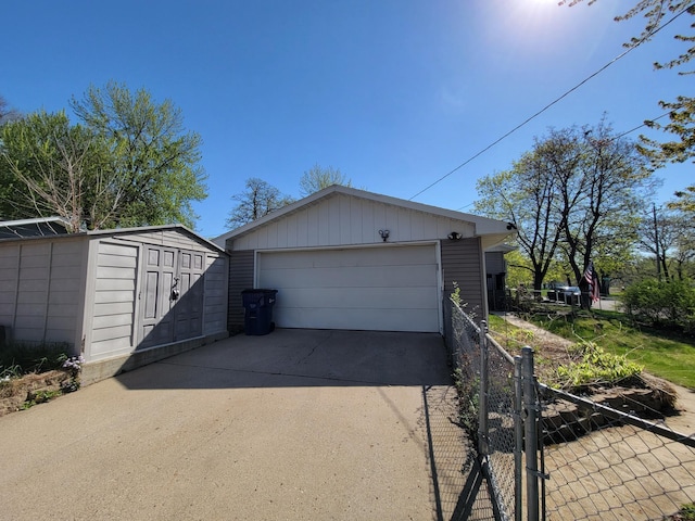 detached garage featuring fence