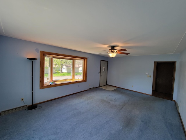 unfurnished room featuring a ceiling fan, carpet, and baseboards