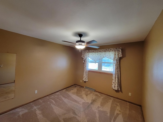 empty room featuring a ceiling fan, carpet flooring, and baseboards