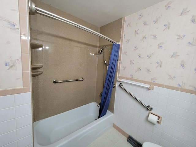 full bath with tile walls, shower / bath combo, wainscoting, wallpapered walls, and tile patterned flooring
