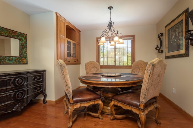 5123 Green Meadow Rd SE, Osakis, MN 56360 - dining area with a notable chandelier, baseboards, and wood finished floors