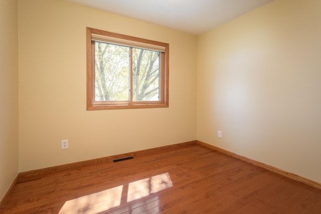 5123 Green Meadow Rd SE, Osakis, MN 56360 - unfurnished room featuring visible vents, wood finished floors, and baseboards