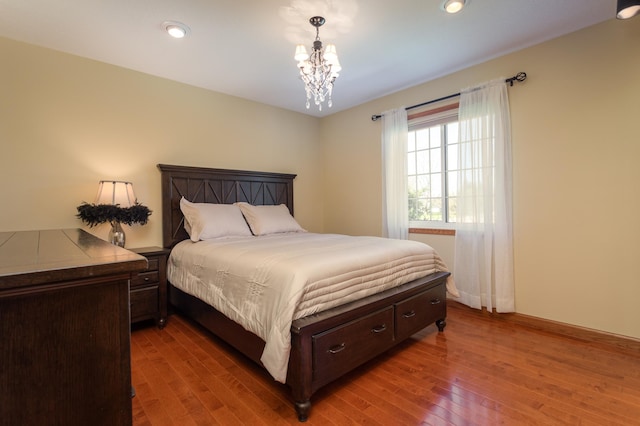 5123 Green Meadow Rd SE, Osakis, MN 56360 - bedroom with an inviting chandelier, recessed lighting, and hardwood / wood-style flooring