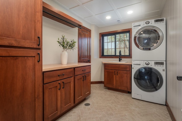 5123 Green Meadow Rd SE, Osakis, MN 56360 - laundry room with recessed lighting, baseboards, a sink, stacked washer / drying machine, and cabinet space