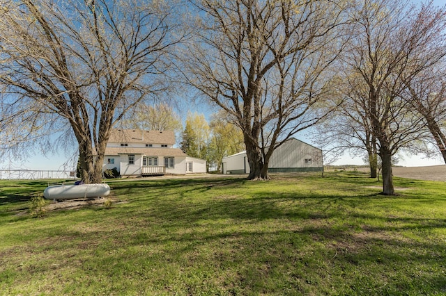 view of grassy yard with a wooden deck