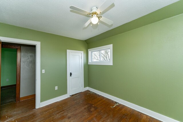 unfurnished bedroom featuring hardwood / wood-style floors, baseboards, and a ceiling fan