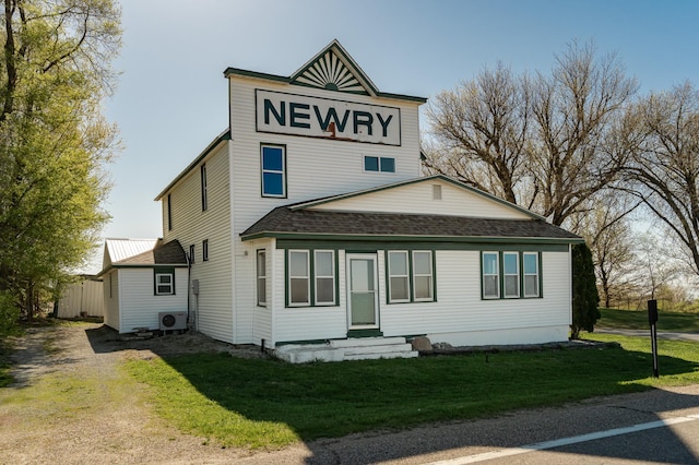 view of front of home with a shingled roof, a cooling unit, a front yard, and dirt driveway
