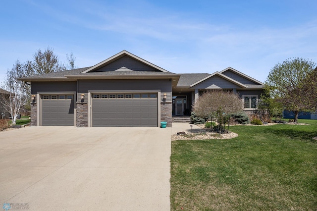 view of front of home with an attached garage, driveway, a front yard, and a shingled roof