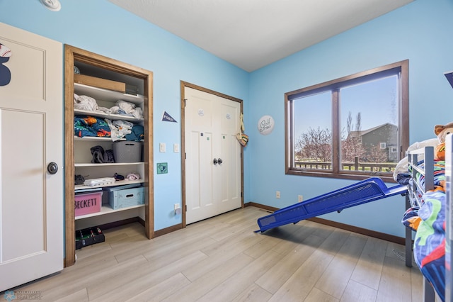 rec room featuring wood finished floors and baseboards