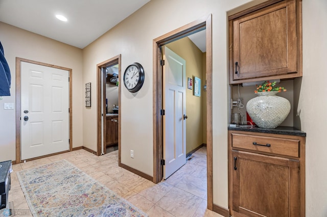 foyer entrance featuring baseboards and recessed lighting