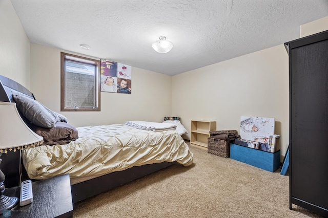 bedroom featuring carpet floors and a textured ceiling
