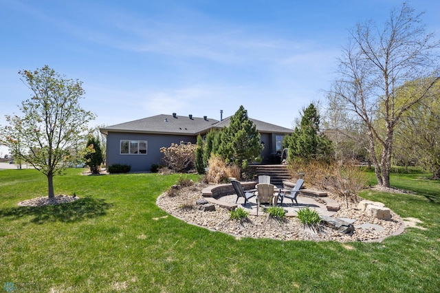 view of green lawn featuring an outdoor fire pit and a patio area