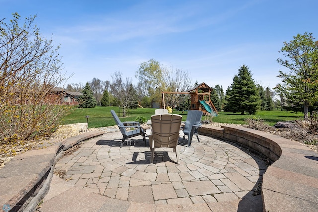 view of patio featuring a playground and outdoor dining space