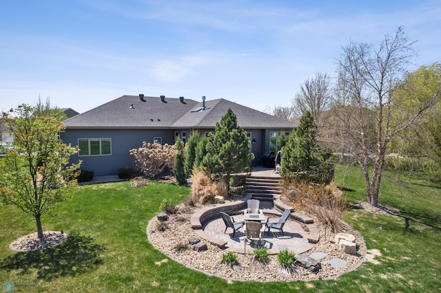 back of property with a fire pit, a patio, and a yard