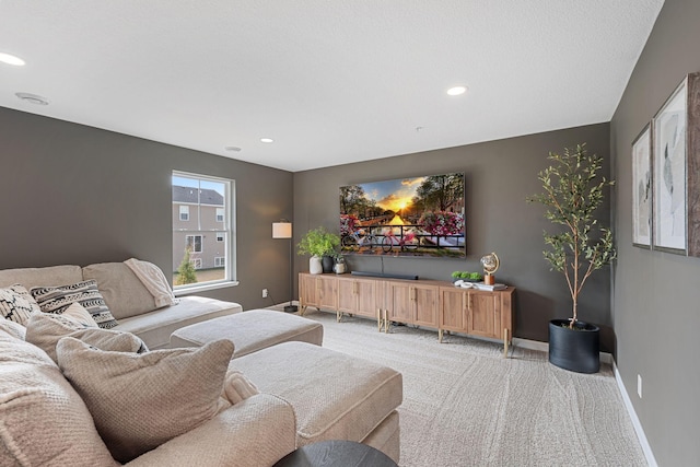 living room featuring baseboards, recessed lighting, and light colored carpet