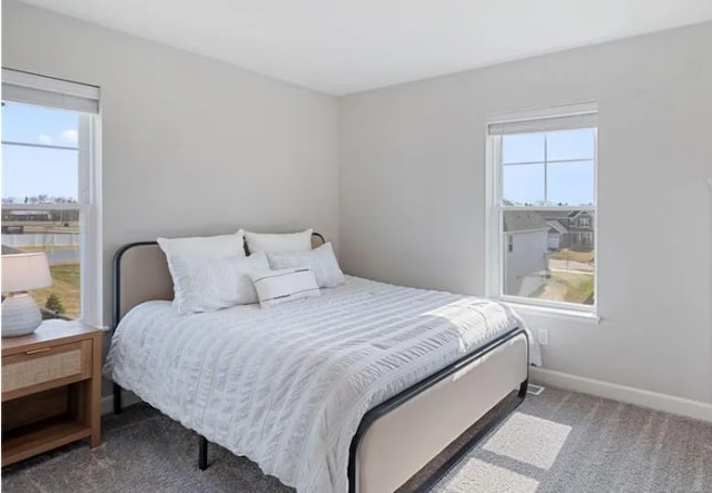 carpeted bedroom featuring baseboards