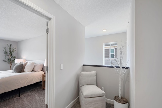 carpeted bedroom with a textured ceiling and baseboards