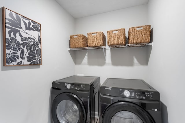 washroom with washing machine and clothes dryer