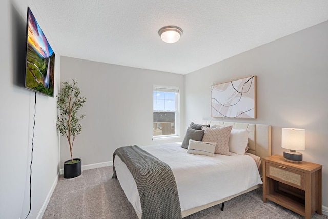 carpeted bedroom featuring baseboards